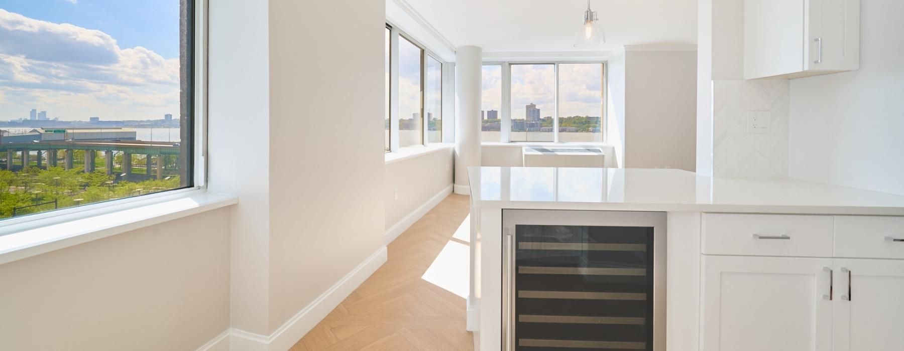 a room with white cabinets and a window