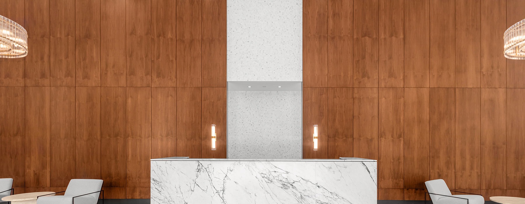 a lobby with a marble counter and wooden wall