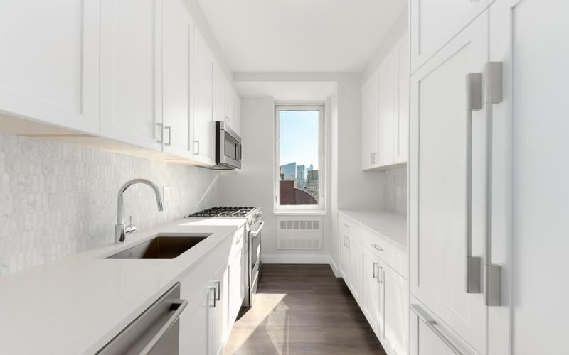 a kitchen with white cabinets